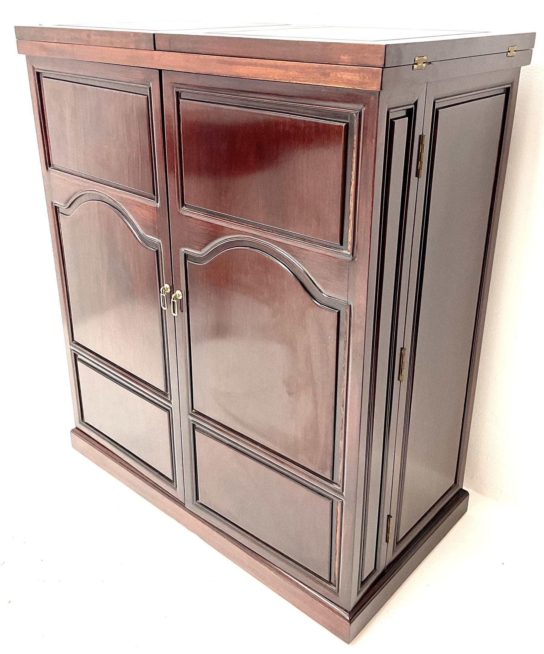 Chinese rosewood cocktail bar, hinge folding top, above two cupboard doors enclosing fitted interior, platform base