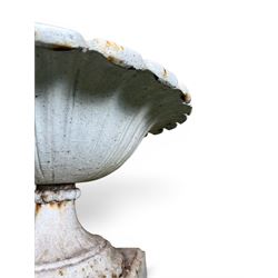 Coalbrookdale - pair of 19th century cast iron petal rim urns, squat form on square plinth, finished in distressed white paint, design registration number 133334, first registered 19 september 1860, number 19 in the Coalbrookdale Castings Catalogue (see illustration)