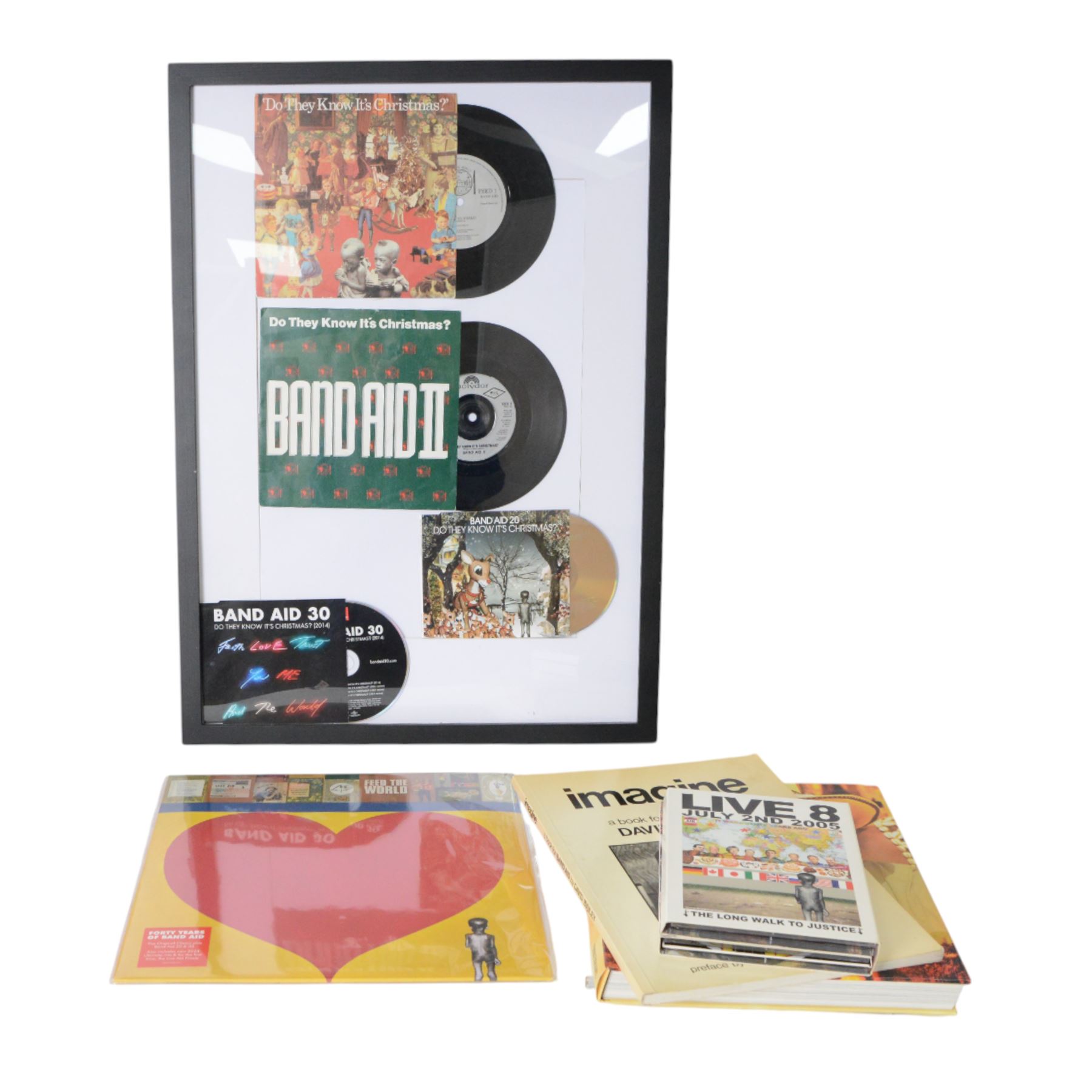 Band Aid vinyls and CDs in framed display, including original Do They Know Its Christmas? and later editions Band Aid II, Band Aid 20 and Band Aid 30, together with limited edition 40th anniversary edition Feed The World 12