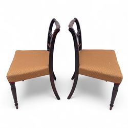 Pair of Regency mahogany side chairs, reeded bar backs centred by oval paterae, overstuffed seats upholstered in gold geometric patterned fabric, on turned tapering front supports 