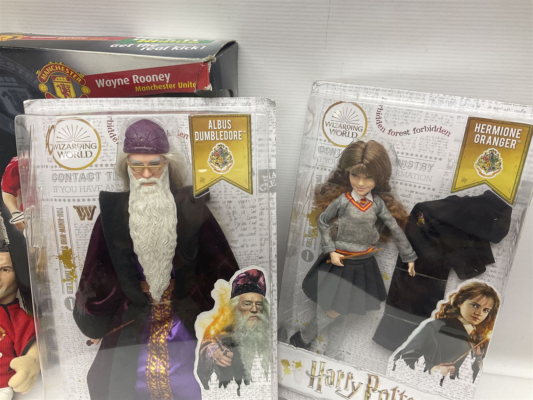 Three Mattel carded Harry Potter dolls - Harry, Hermione & Dumbledore; Vivid Imaginations Take That Robbie doll; all boxed; three Manchester United figures of players (one boxed); and The Simpsons 3-D Chess Game; boxed