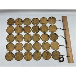 Attributed to Hornsea Pottery wall hanging, with 30 geometric circles attached to a wooden beam, H70cm 