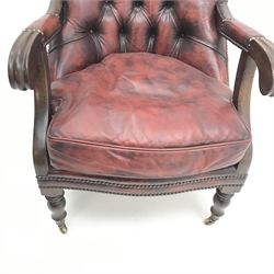  Chesterfield style library armchair, upholstered in deep buttoned ox blood leather, turned supports, brass castors, W60cm  