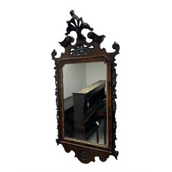 19th century Chippendale design wall mirror, the pierced cresting finial carved with extending foliate decoration, flanked by a broken pediment with moulded acanthus decoration, trailing foliage and flower heads, rectangular plate within a gilt moulded slip, the carved uprights decorated with foliate garlands, the terminal carved with a recessed rosette