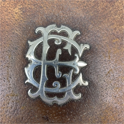 A Victorian silver mounted leather blotter, of rectangular form, the cover with two corner silver mounts and a central silver monogram, hallmarked Carlile & Watt, Edinburgh 1888, H29cm. 
