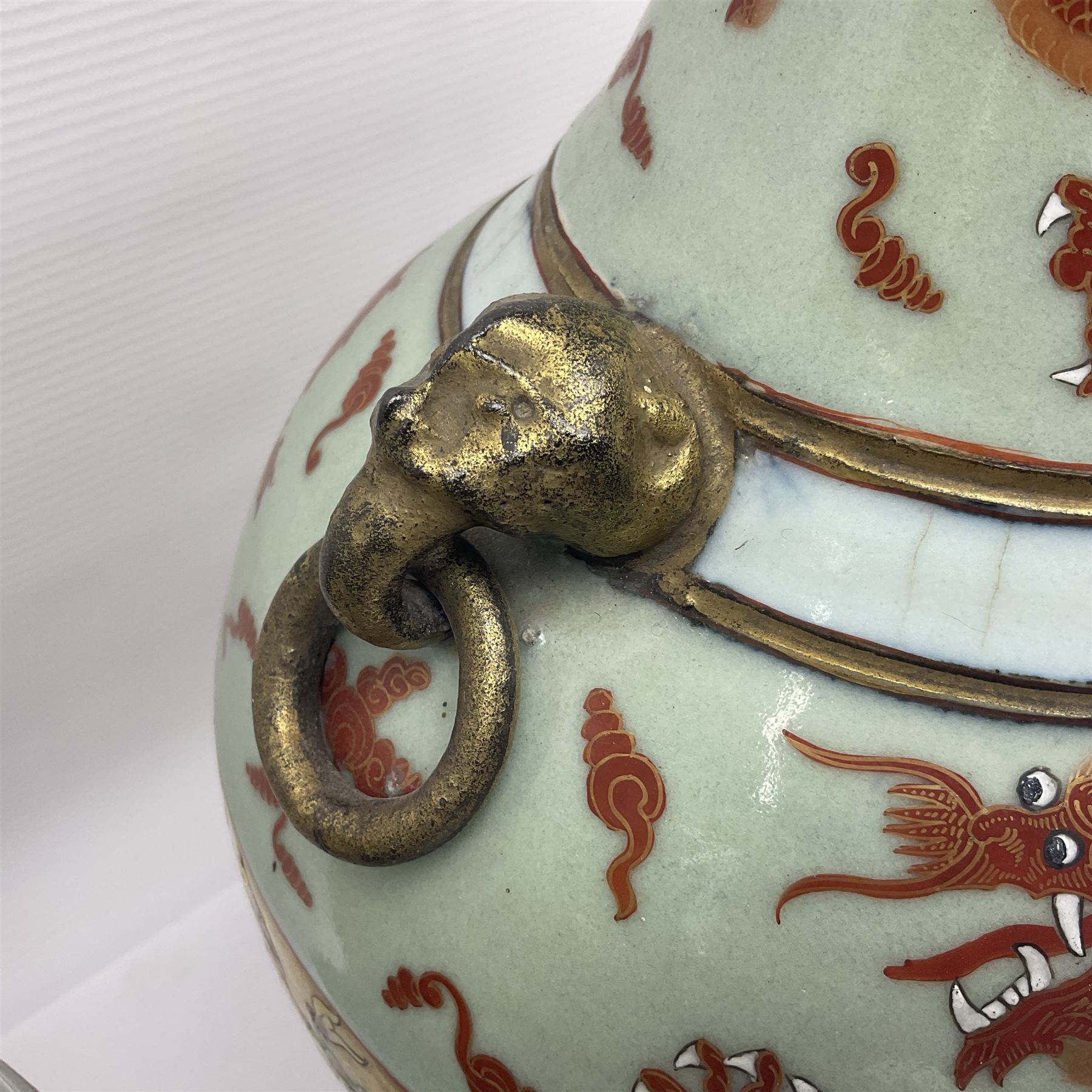 Pair of early 20th century Chinese vases decorated with dragons chasing a flaming pearl, with a gilt border of butterflies and floral sprigs, with Elephant head handles, H44cm 