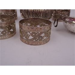 Group of Indian silver, to include a set of eight filigree napkin rings, an open salt, of circular form with foliate decoration to body and a tea strainer with a horn handle, salt H3.5cm