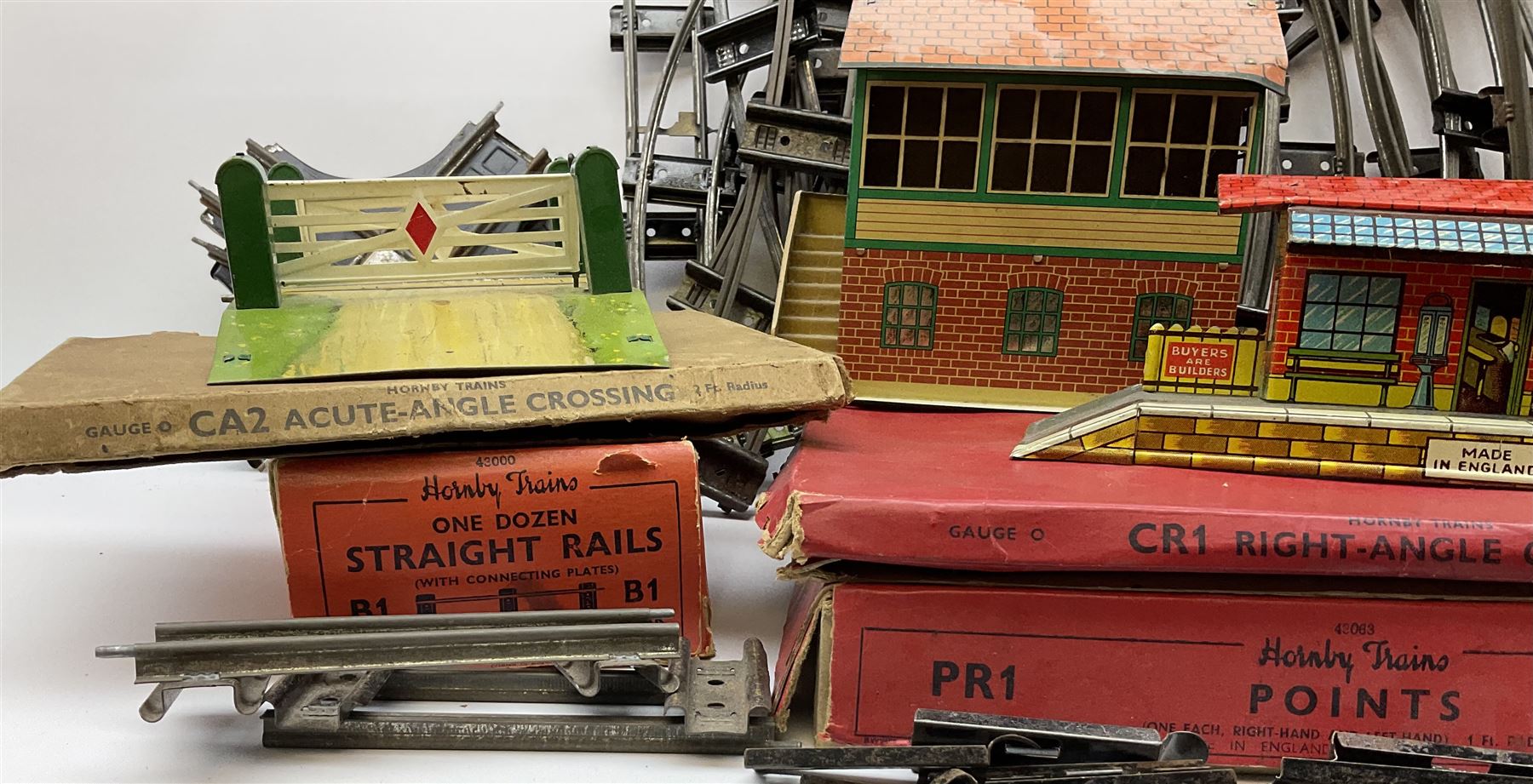 Hornby '0' gauge - layout accessories comprising PR1/PL1 Points, CR1 Right Angle Crossing and CA2 Acute Angle Crossing, all boxed; tin-plate signal box; tin-plate level crossing; textured wooden tunnel, possibly pre-WW2; and quantity of track, some boxed; together with '00' gauge tin-plate station