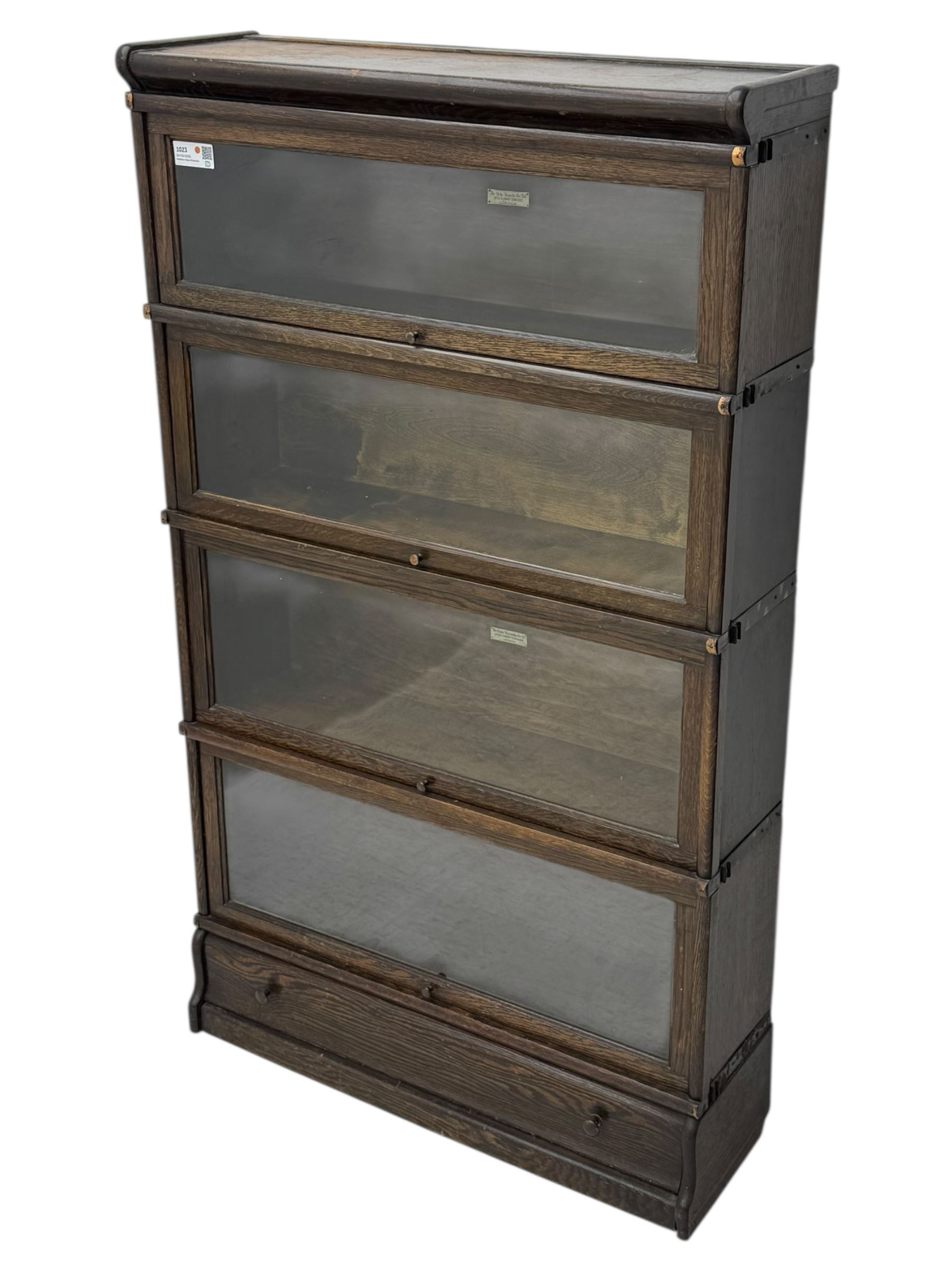 Globe Wernicke - stacking sectional library bookcase, over four glazed up-and-over doors, each bearing original makers mark, on moulded plinth base with inbuilt drawer