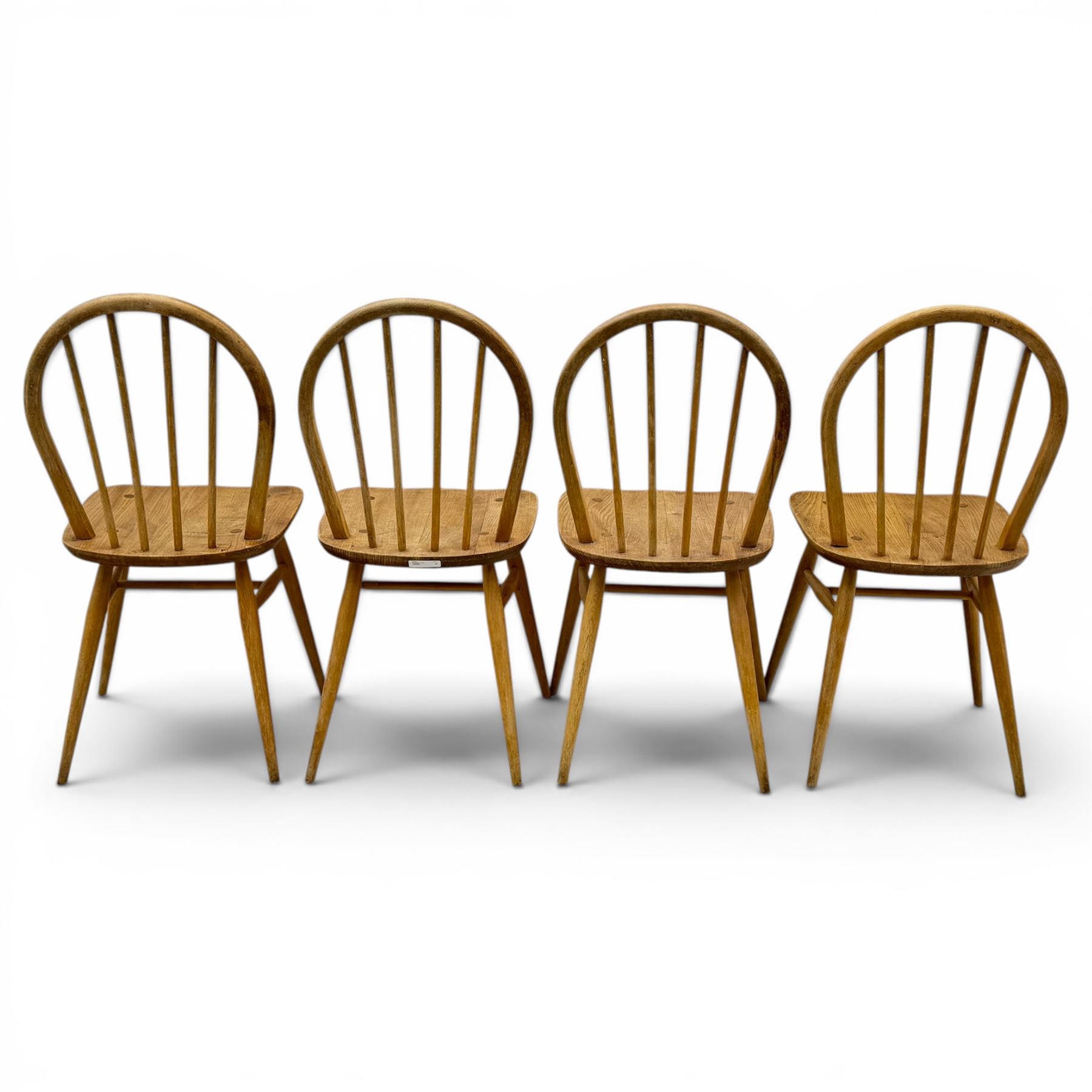 Ercol - set of four elm 'Windsor' chairs, hoop design back dish seat, tapering supports united by H-stretcher 