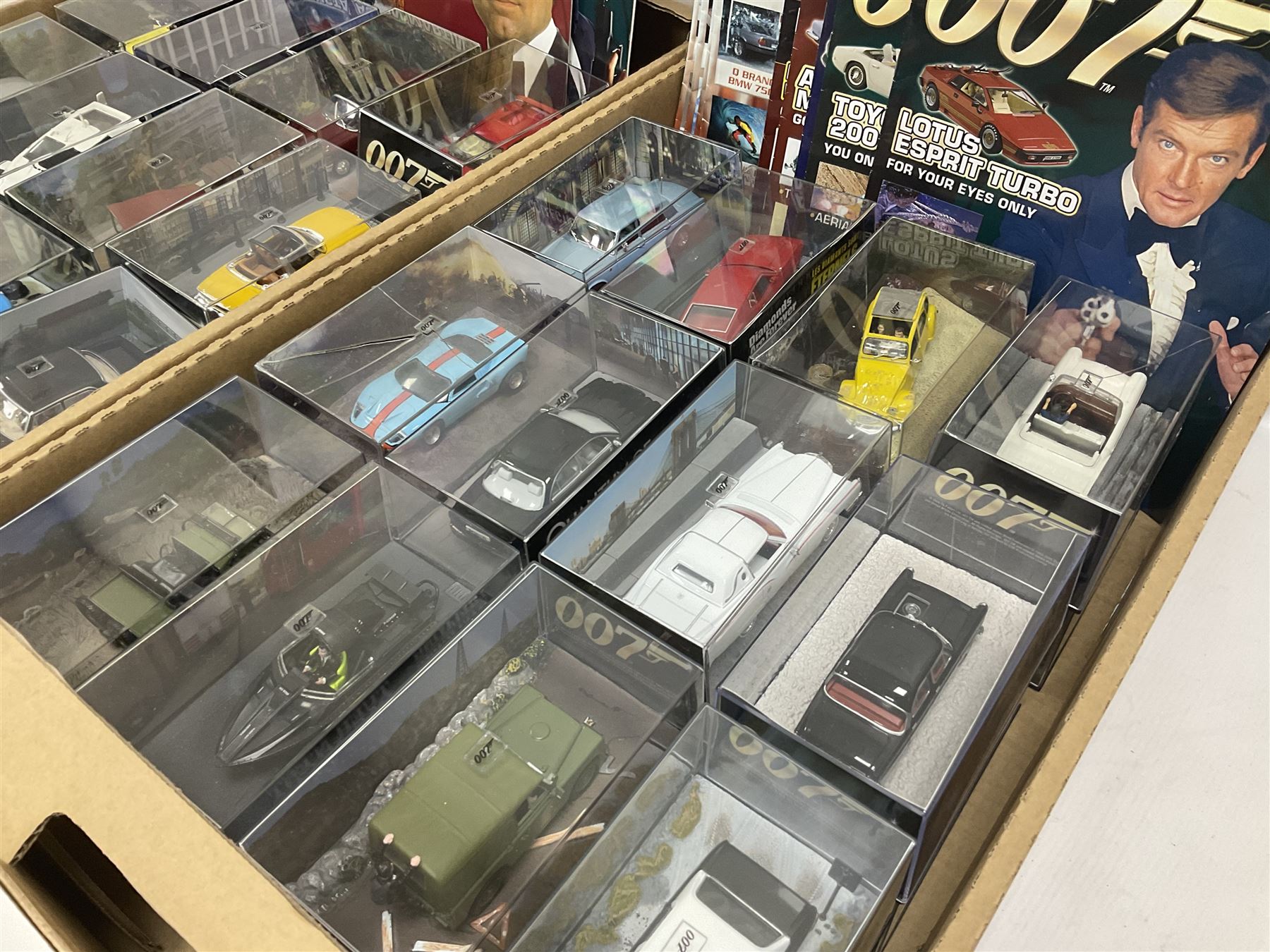 Fabbri James Bond Collection - over one hundred and ten die-cast models in perspex display cases as issued periodically; and a quantity of associated magazines and trading cards, in five boxes