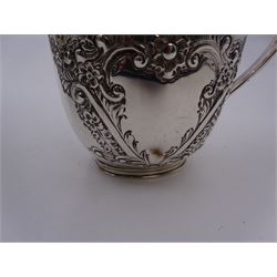 Late Victorian silver milk jug and twin handled open sucrier, each of oval form with angular handles and embossed floral, foliate and C scroll decoration, hallmarked James Deakin & Sons, Sheffield 1899, sucrier with handles H10.8cm