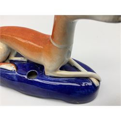 Pair of Staffordshire recumbent greyhound pen holders 