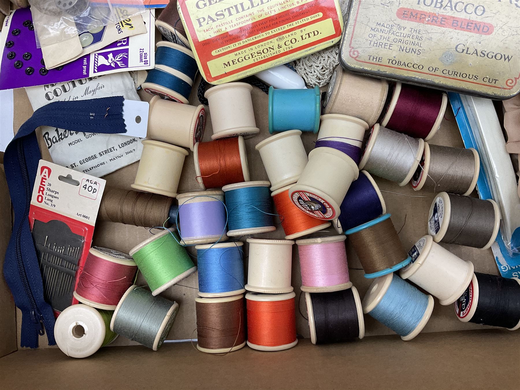  Victorian sampler worked with the alphabet by Carrie Monkman 1886, Victorian silver-plated cigarette case, Carlo simulated tortoiseshell motorised fan in case, Folding Opera Glasses, two chrome leaping Jaguar brooch and matching pin badge, quantity of sewing threads, lace etc