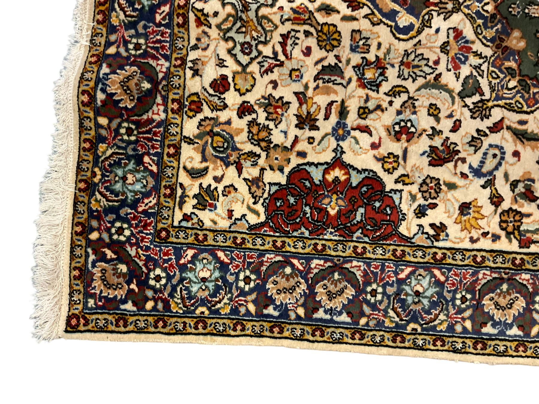 Persian ivory ground rug, central green floral pole medallion within a field decorated by scrolling foliate patterns, the guarded border with repeating palmettes and floral designs