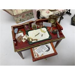 Collection of miniature dolls house furniture, to include five drawer chest painted with blossom, cream and gilt double door mirrored wardrobe, four piece lacquered style desk set, three piece suite, writing desk, wash stand, Knoll style sofa etc (14)