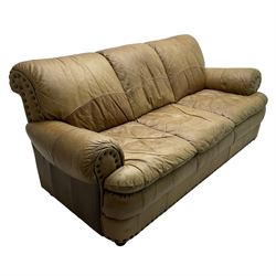 Large three-seat sofa upholstered in stitched brown leather with stud work decoration, rolled back and arms