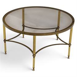Regency style brass and glass circular table, smoked glass top mounted to a brass frame with fluted supports united by stretchers