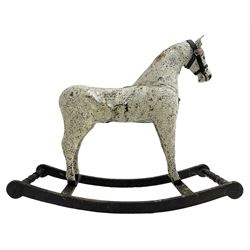 Late 19th to early 20th century painted leather dappled grey rocking horse, with leather bridle, on ebonised base with turned end stretchers