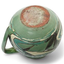 Late 19th century C H Brannam pottery Barum ware sgraffito jug, in green and brown glaze, decorated with fish swimming amongst reeds, signed and dated 1892 to base, H10cm 