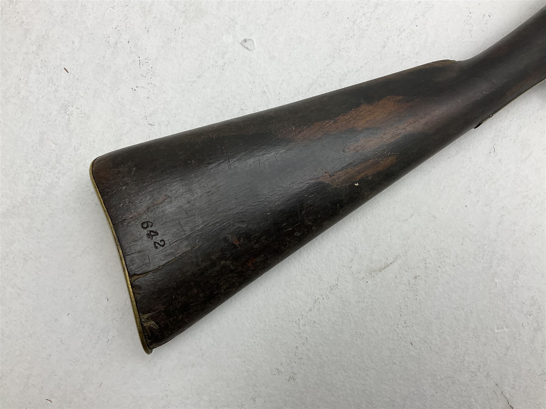 20th century Indian percussion musket, the 76cm barrel with two bands, indistinctly inscribed lock-plate, walnut full stock stamped 642 with brass butt and trigger guard and under barrel ramrod channel L121cm overall