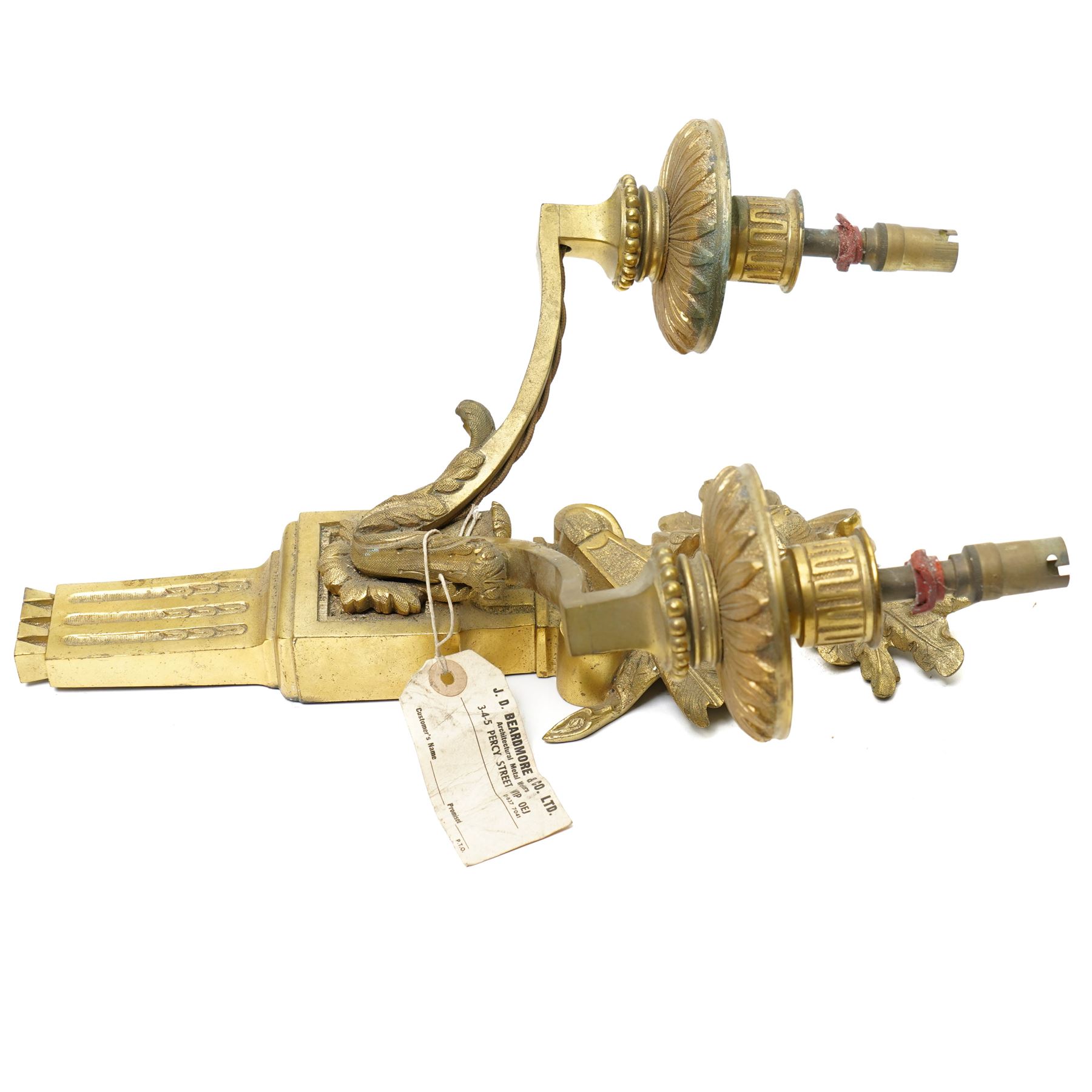 Period design gilt brass wall light, by Beardmore, London, with French empire motifs, including a helmet, oak leaves and acorns, quiver, each arm with acanthus leaf decoration, wired for electricity, with original label, H36cm  
Provenance: property of a Nobleman