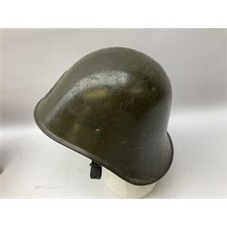 WW2 French M-26 Adrian Pattern Steel Helmet, original olive drab paint finish; flaming grenade badge to the front signifying issue to an Infantry regiment; original leather liner and leather chinstrap; and WW2 Dutch steel helmet with liner and chin strap (2)