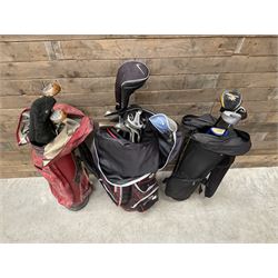 Various golf clubs in three bags