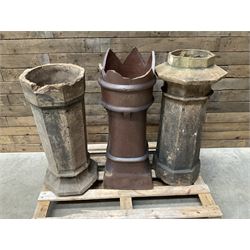 Collection of three Victorian and early 20th century reclaimed terracotta chimney pots, comprising: one cylindrical form with weathered, cracked glaze and flared octagonal base; one deep red cylindrical pot with fluted midsection and castellated rim, bearing moulded number ‘25’; and one tapering hexagonal example with wide flared rim and weathered patina. All with age-related wear and chips, consistent with use and outdoor exposure. Plus a selection of cast stone pieces including fountain 
