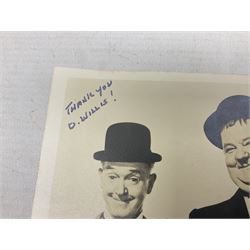 Stan Laurel and Oliver Hardy signatures on head and shoulder portrait of the two comedians inscribed 'THANK YOU D. WILLIS' 9 x 12.5cm