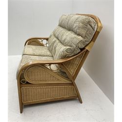 Light wood and cane two seat conservatory sofa, loose beige patterned cushions
