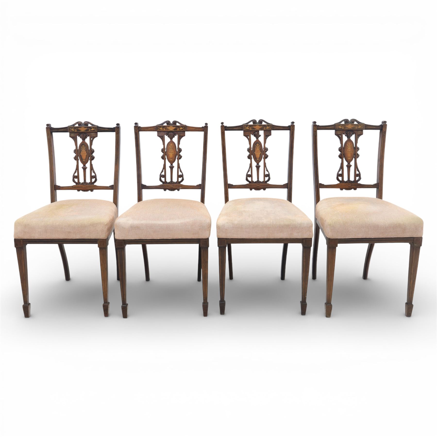 Quality Edwardian seven piece inlaid salon suite, comprising three seater settee, pair of arm chairs and four chairs with pierced splat backs, upholstered in pale pink fabric, inlaid with flowering urns, upon tapering legs with spade feet and castors