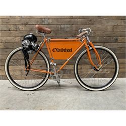 Fully restored vintage advertising bicycle with 2 stroke petrol engine, orange frame, tan leather seat