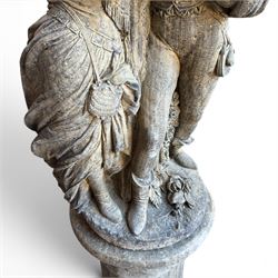 Composite garden statue group of Romeo and Juliet embracing, the couple adorned in Medieval dress standing on a naturalistic base with fallen flowers, raised on a Neoclassical fluted pedestal with Anthemion leaf motifs