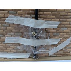 1:24 scale stone effect three-storey cottage dolls house, with green arched door and lattice effect windows, decorated to the interior with wooden floors, wired lighting and fire places, H45cm, W57cm, D26cm