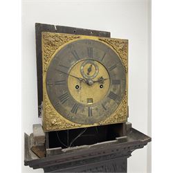 18th century oak longcase clock with later carving, the hood with projecting cornice over square glazed door, trunk door carved with tree of life, foliage carved base, on ogee bracket feet, brass dial with Roman chapter ring and subsidiary seconds and calendar aperture, ornate mask cast spandrels, twin train driven movement striking on bell 