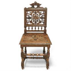 18th century carved oak hall chair, the rectangular pierced back carved with scrolling foliate ornament and central rosette beneath a shaped cresting, the boarded seat carved with stylised foliage, raised on turned legs united by stretchers