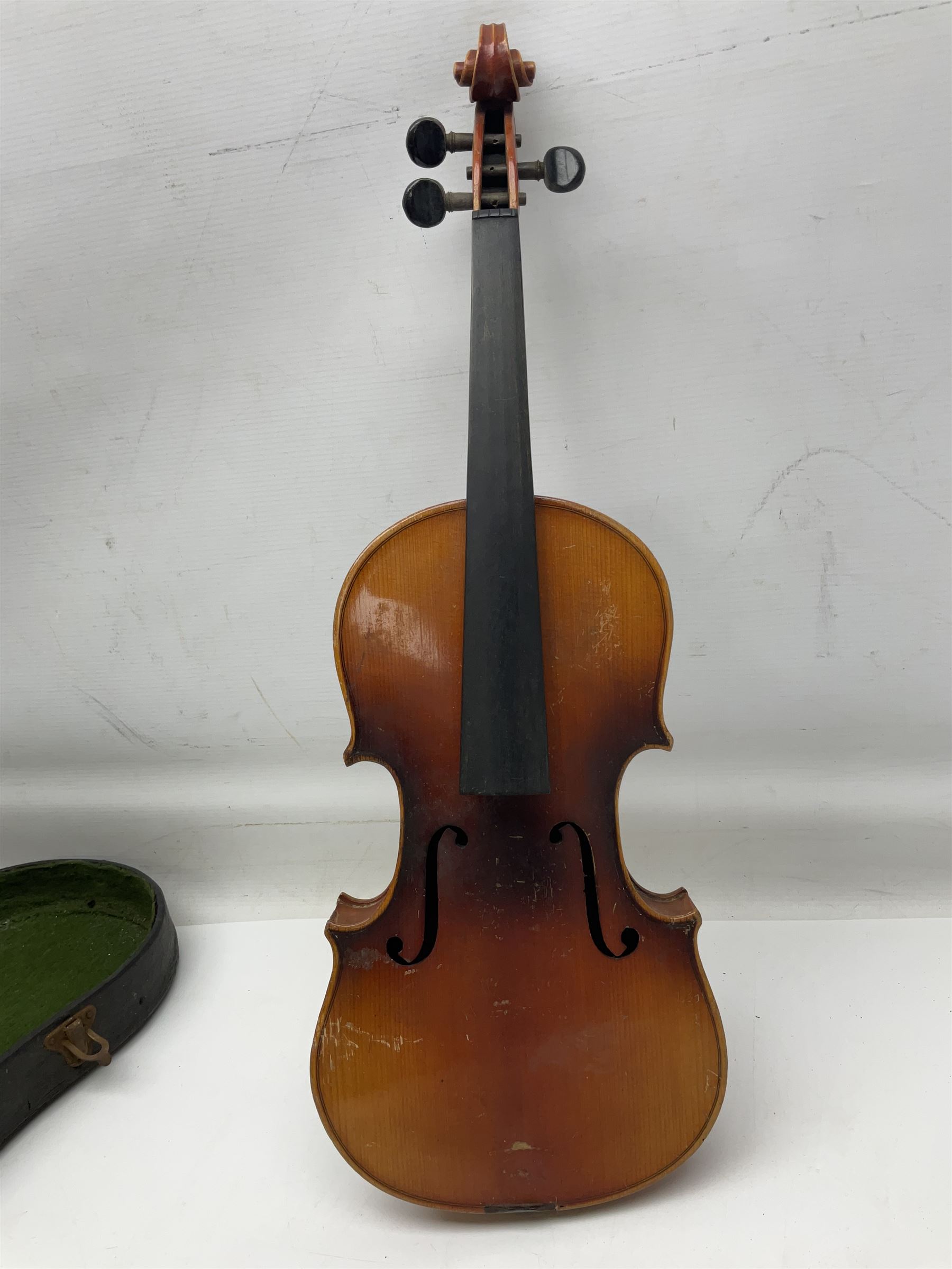 Czechoslovakian violin c1920 with 36cm two-piece maple back and ribs and spruce top, bears label 'Copy of Antonius Stradivarius Made in Czechoslovakia' L59cm; in carrying case; 1950s Czechoslovakian violin; and 195os Czechoslovakian three-quarter size violin; both cased (3)
