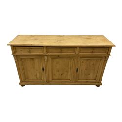 Georgian style pine dresser base, the rectangular top over three drawers and three cupboards, fluted uprights with foliate carved brackets