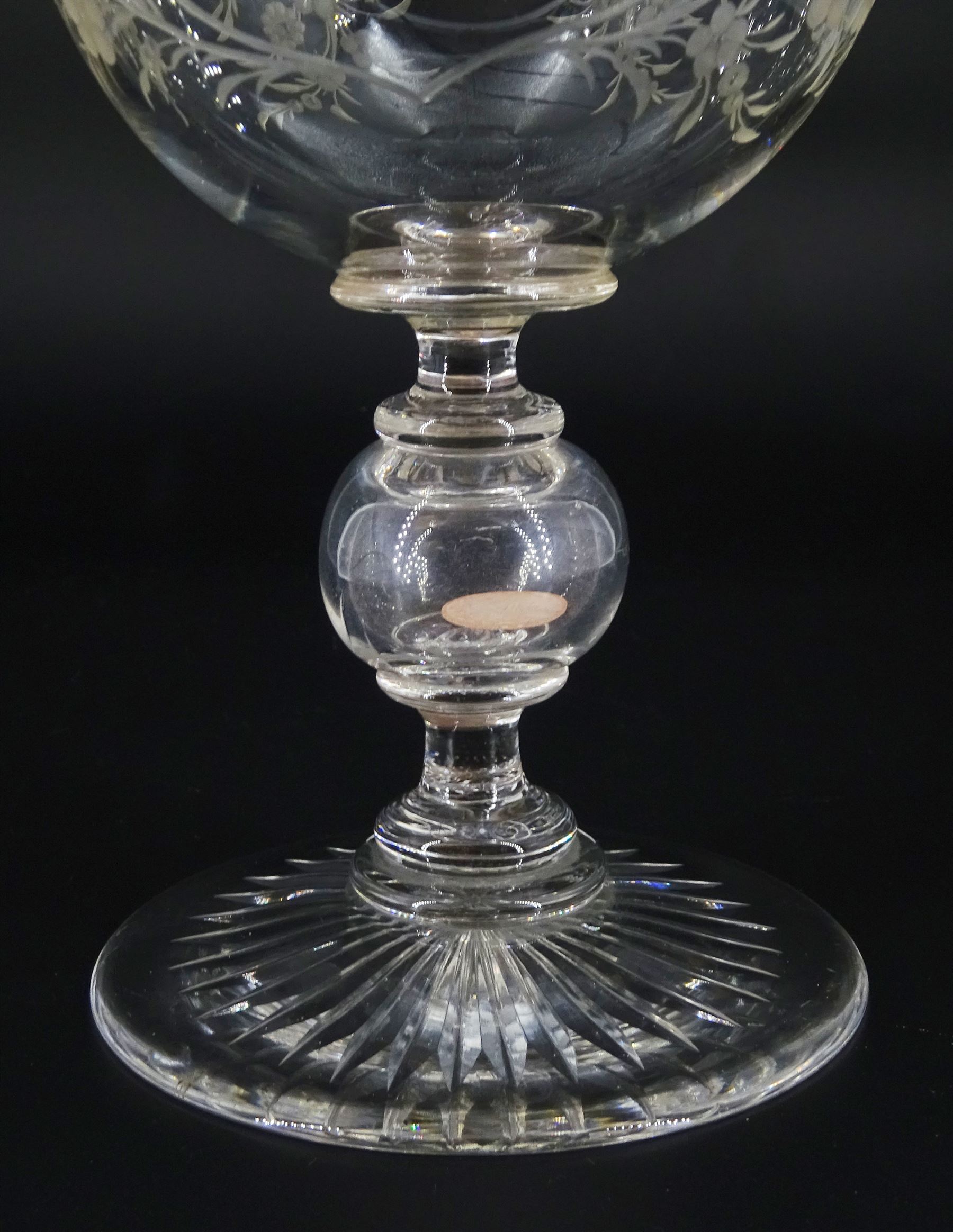 Late 19th century oversized glass goblet, the bowl engraved with cartouche containing dedication 'Jams Michie Died Jan 6th 1871 Aged 26 Years', surrounded by foliate detail, upon a hollow knopped stem containing a silver Victorian 1861 threepence and circular foot with star cut base, H19.5cm