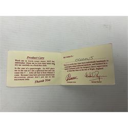 Two Isle of White glass vases, by Alum Bay Glass, both with blue swirl design upon an iridescent mottled blue/green ground, together with a Gozo Glass vase of pebble form, with similar design, H12cm