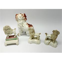 A pair of Victorian Staffordshire figures modelled as poodles, each carrying basket of flowers, together with a further Staffordshire poodle figure, and a 19th century Staffordshire Spaniel with separate front legs, H13.5cm. (5). 