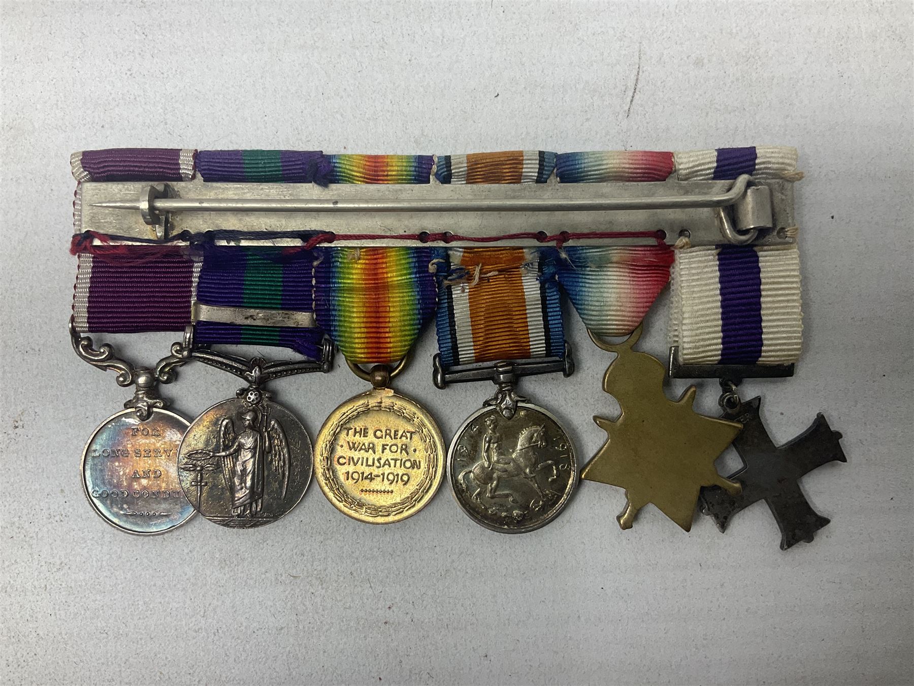 George V Military Cross miniature group of six medals comprising MC, WW1 trio including 1914 Star, Long Service and Good Conduct Medal and General Service Medal with Iraq clasp; and miniature group of four medals comprising Military OBE and WW1 trio including 1914-15 star; all with ribbons and both on pinned wearing bars