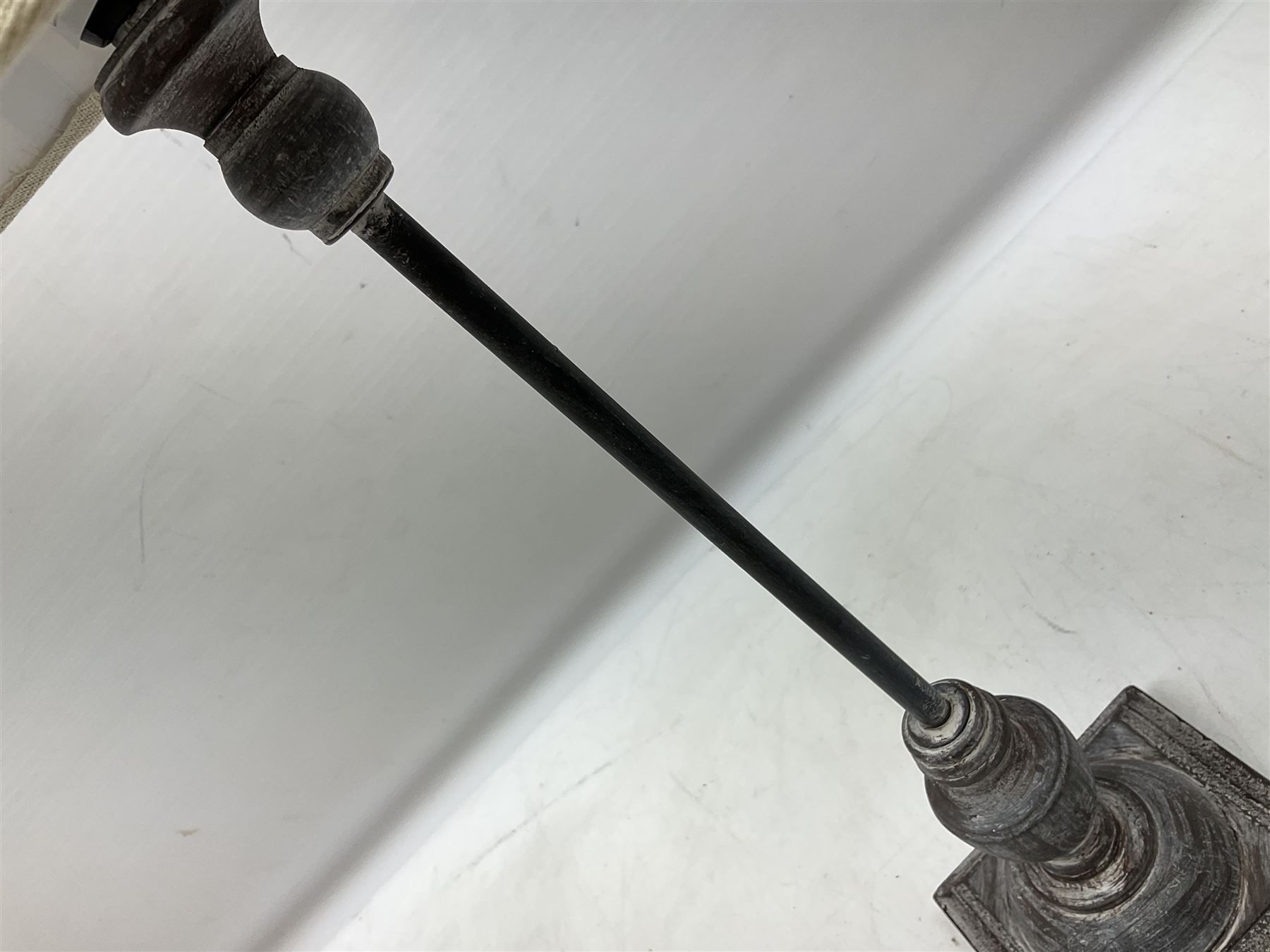 Table lamp, with a thin central stem upon a square stepped base, natural linen shade