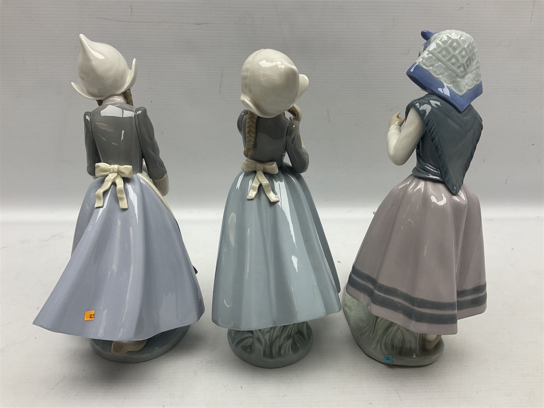 Three Lladro figures, comprising Dutch Girl with Braids no 5063, Dutch Girl with Duck no 5066 and Aracely with Ducks, all with original boxes, largest example H25cm