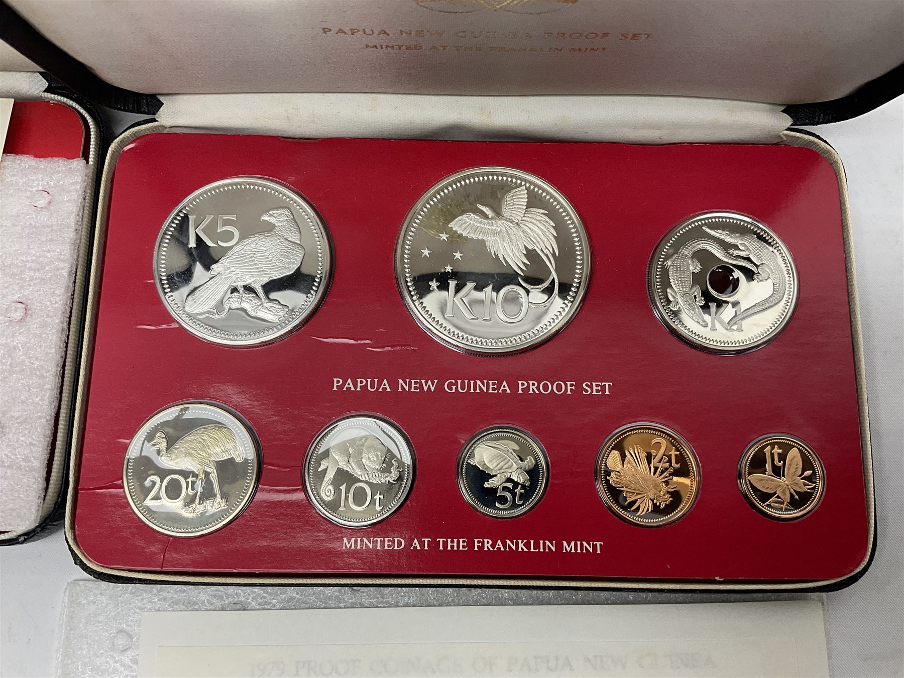 Four Papua New Guinea proof eight coin sets, from ten kina to one toea, comprising First Coinage of Papua New Guinea 1975 proof set, 1976, 1977, and 1979 proof sets, the 1977 and 1979 sets containing 925 silver ten kina and 500 silver five kina coins, all minted at the Franklin Mint, cased with certificates (4)