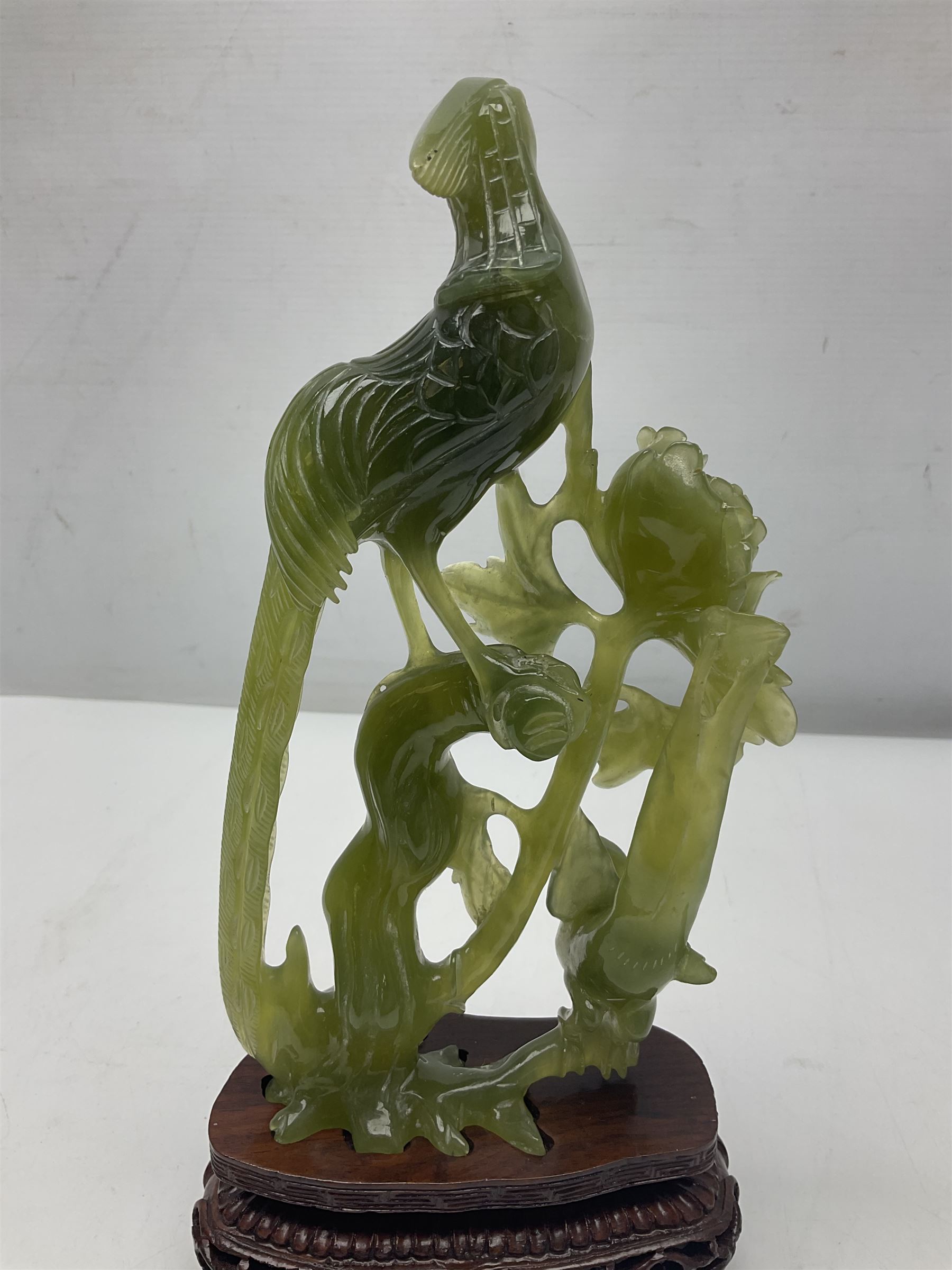 Carved jade figure of a phoenix perched on a flowering branch, upon a wooden stand, with original box, H27cm