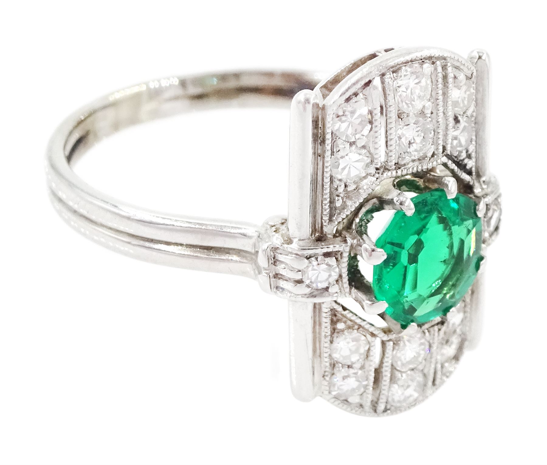 Art Deco 14ct white gold emerald and diamond panel ring, the central round cut emerald of approx 0.45 carat, within a pierced octagonal setting, flanked by a single cut diamond either side and three rows of milgrain set, single cut diamonds, to a reeded shank, stamped 585, total diamond weight approx 0.55 carat