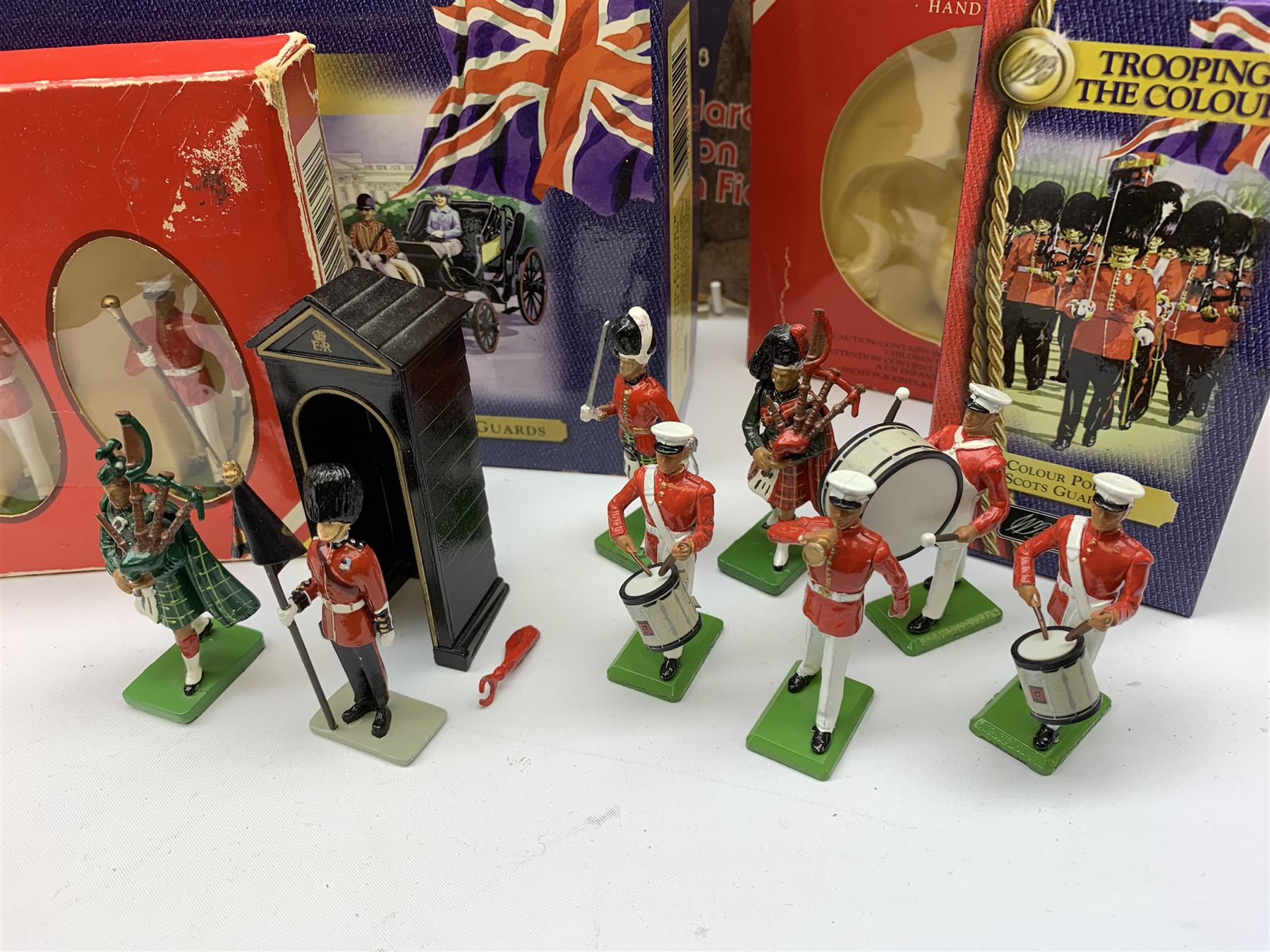 Britains - four Trooping the Colour sets 40109, 40110, 40112 & 40113; The Duke of Wellington with 95th Rifleman No.41160; and 8819 Lancer figure from the 16th Queens Lancers; all mint and boxed; together with a quantity of unboxed figures etc; and collection of books and magazines on model soldiers