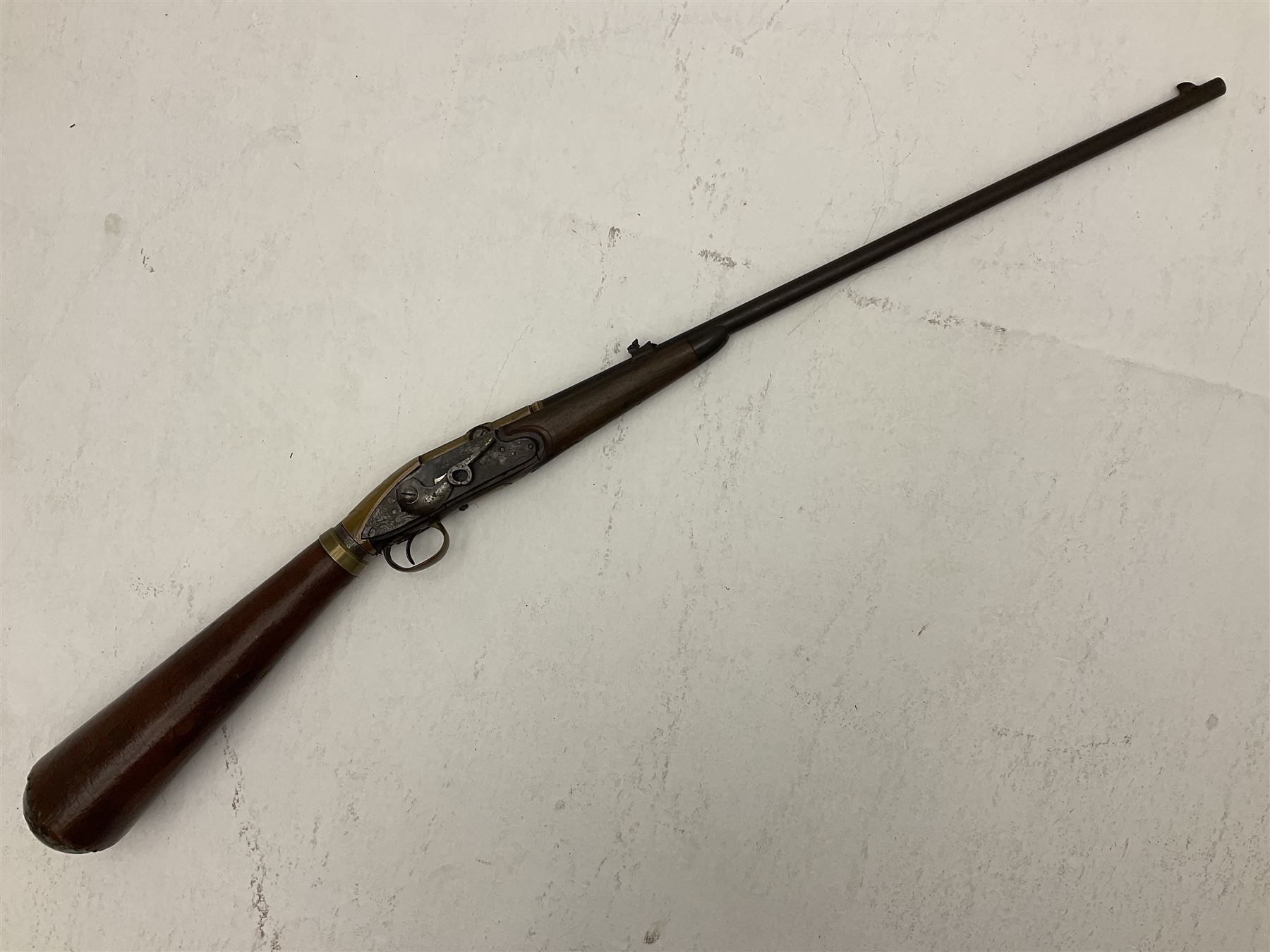 Late 18th century 7.2mm (approx. .28 calibre) Girandoni system single shot reservoir air rifle, the 62cm steel barrel with swivelling two-leaf rear sight, brass breech decorated with a sunburst and lever opening top loading, engraved steel lock-plates marked 'S. Gaskell' to the right side underneath the cocking lever, brass trigger guard,  leather covered steel butt reservoir of tapering conical form with brass ferrule and walnut fore-stock with horn mounts L107cm overall